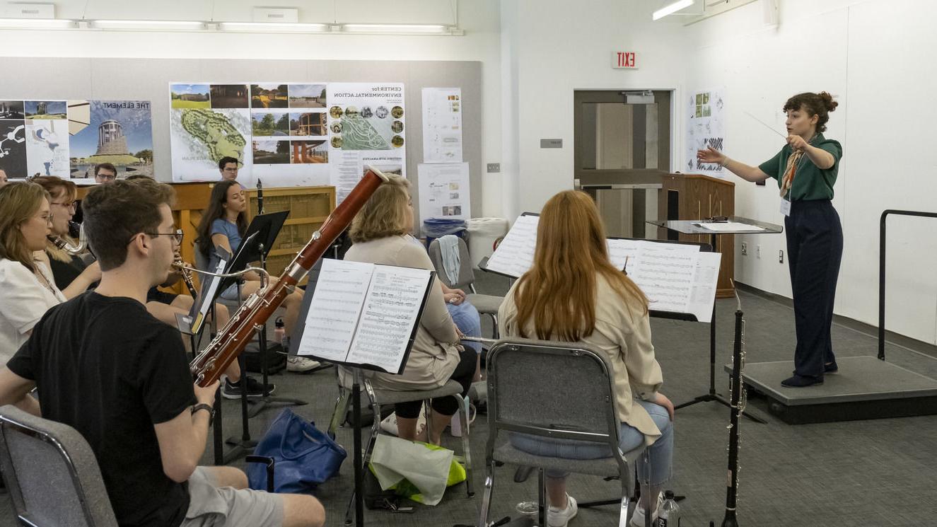 An image of individuals attending a conducting workshop. 