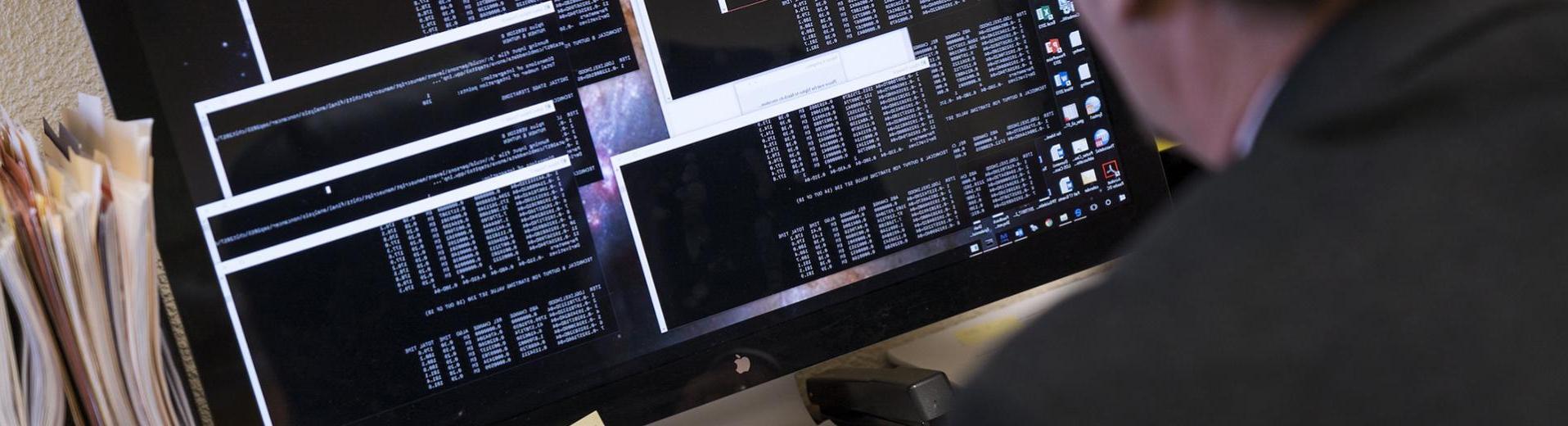 Applied biostatistician working on a computer